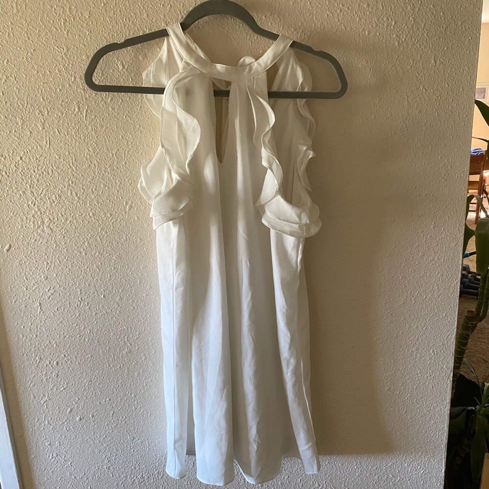 White dress, fun sleeves. Ties in back.